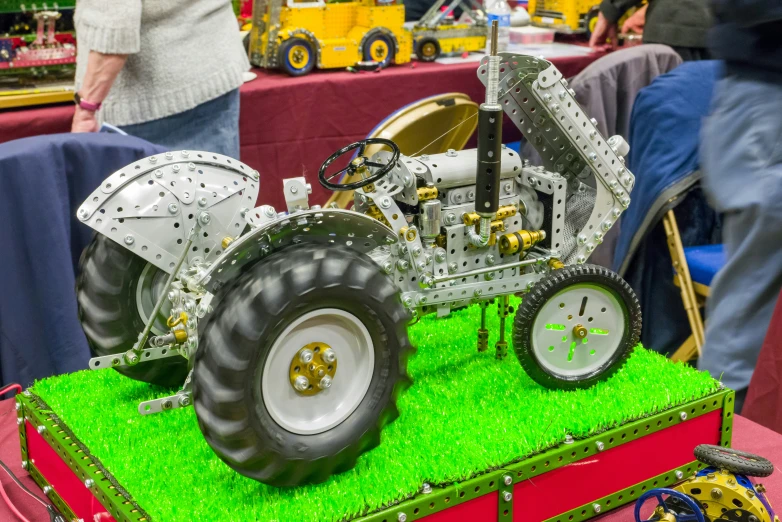 toy car with multiple wheels on display at an exhibition