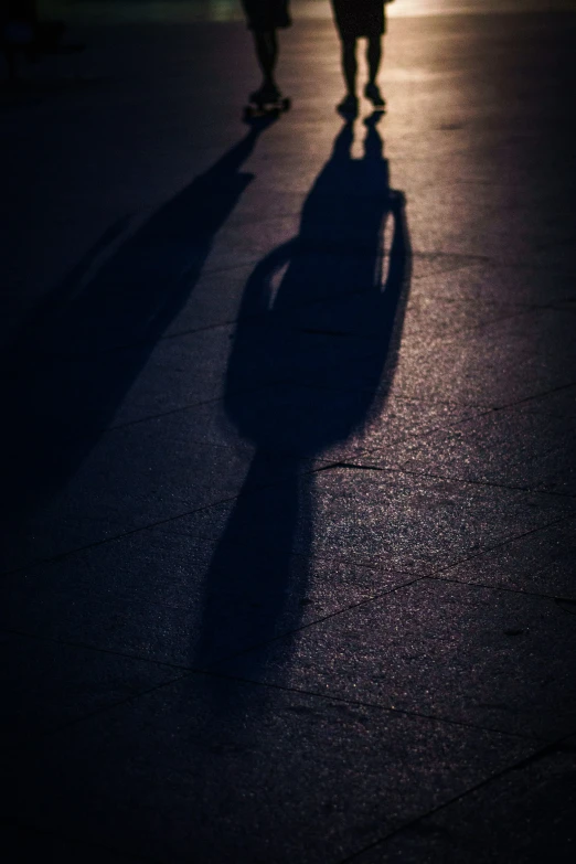 two people walking on a street during the day