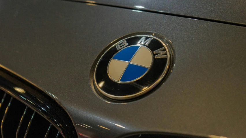 close up of a bmw logo on the front of a car