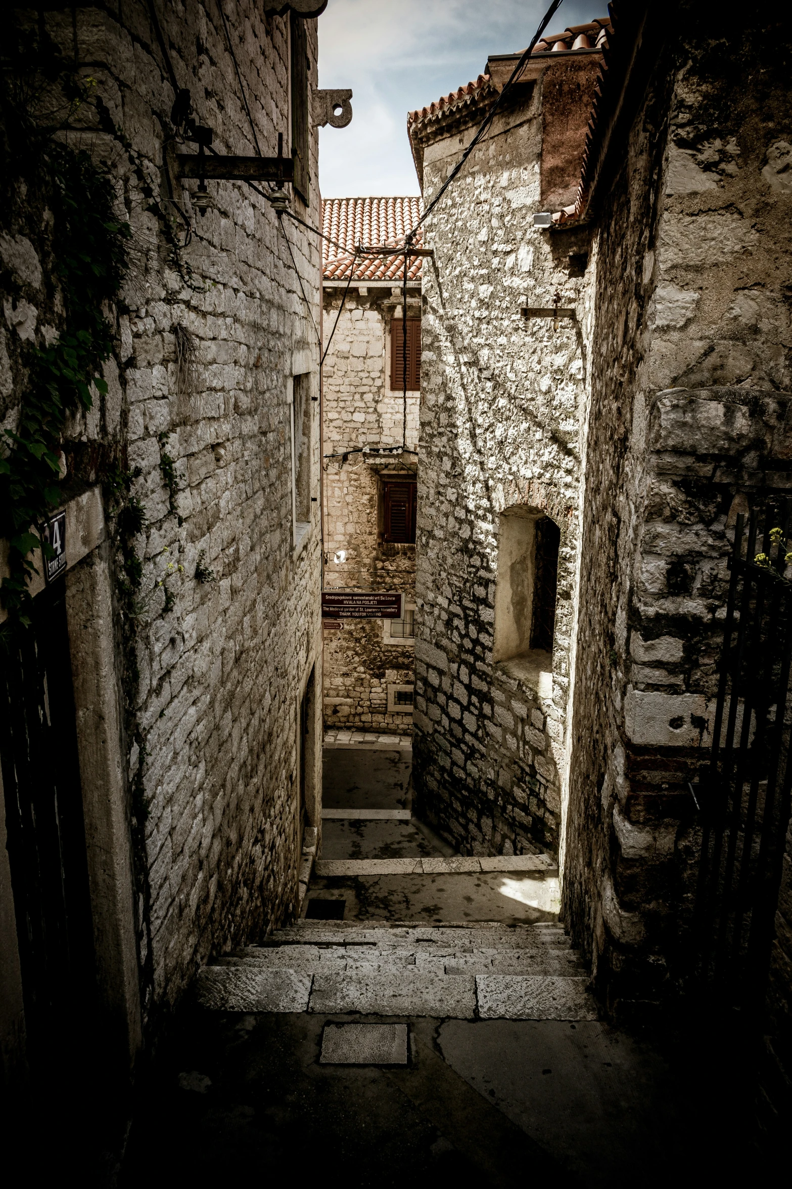 a narrow brick street that is between two buildings