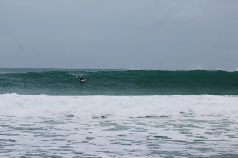 a surfer surfing on a big blue ocean