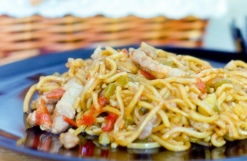 some noodles are topped with vegetables and shrimp