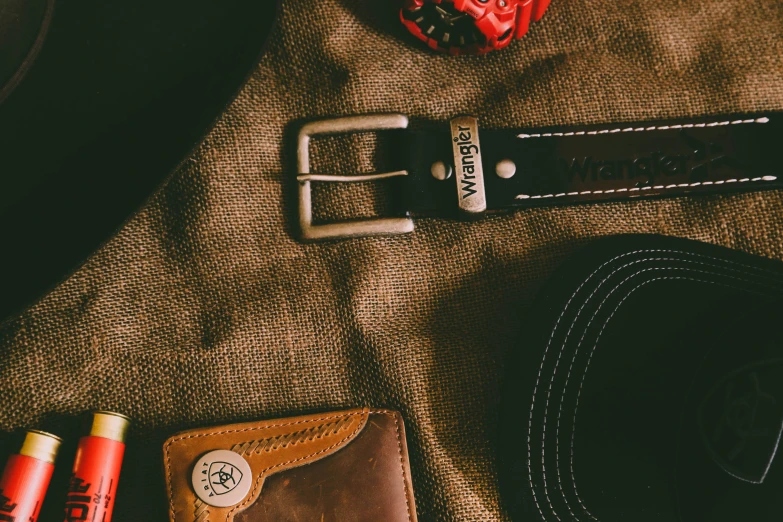 a hat, belt, and other items laid out on the table