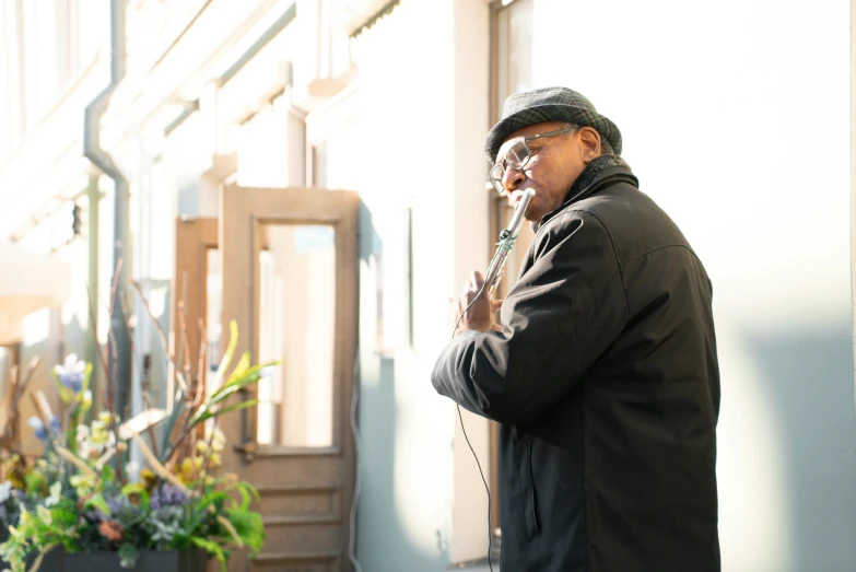 an old man standing in front of a building