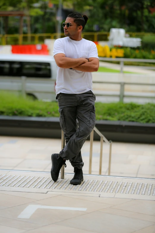 a man wearing black pants and white t - shirt