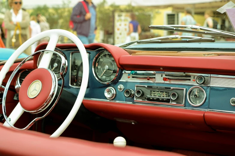 the inside of an old car with red and blue trim