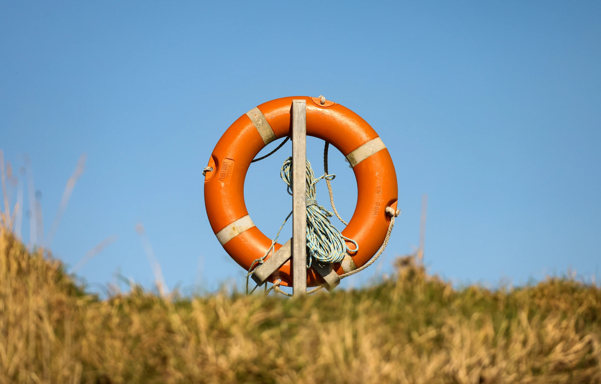 an orange life ring hanging off the side of a cliff