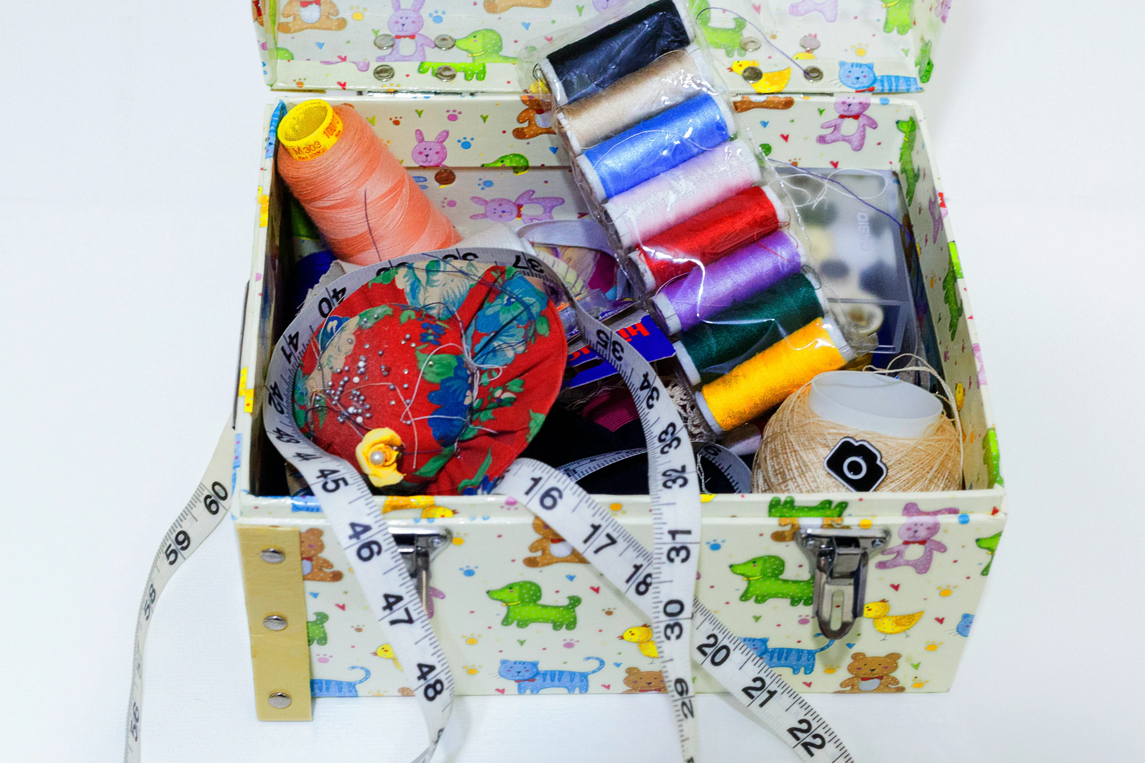 a suitcase filled with different types of needle and thread