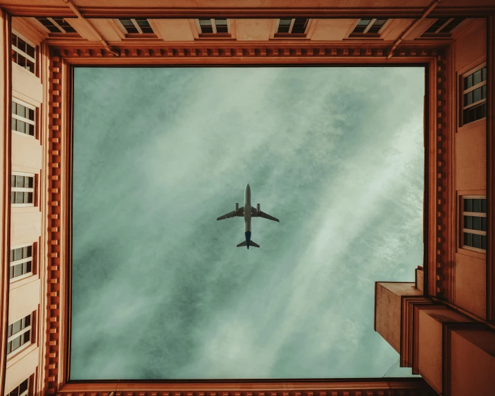 a view from below of a large plane in the air