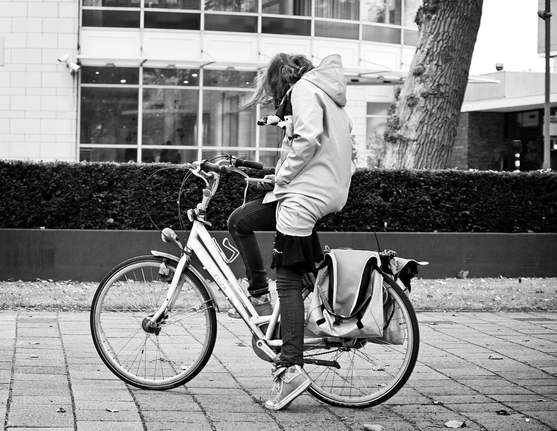 a man riding his bicycle on the sidewalk