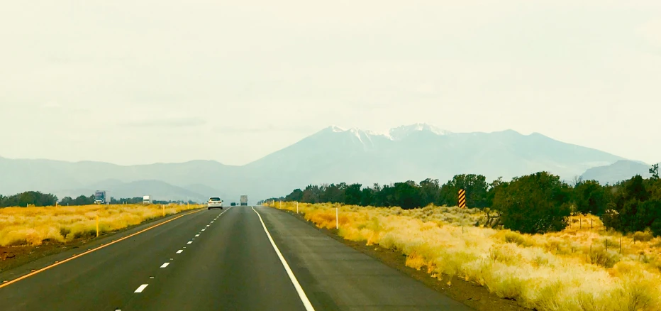 the road looks as if it's empty, but with mountains on the horizon