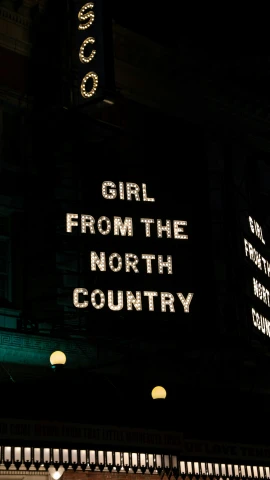 the illuminated sign of the theatre's name on the building