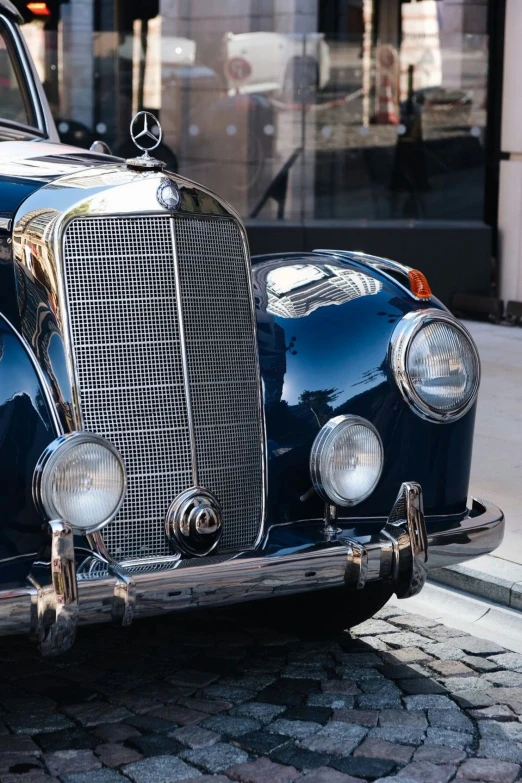 an old car parked on a street next to a building