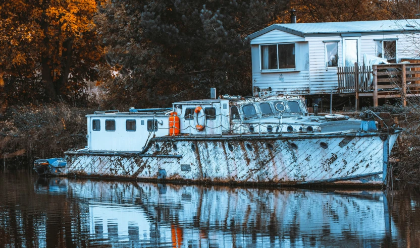 a small boat is moored on the river bank