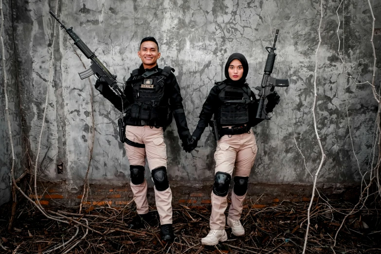 two male and female divers wearing paint scheme holding guns
