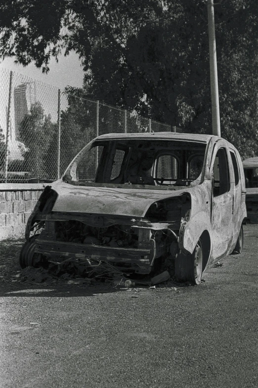 this old car has been damaged and has been parked in the middle of the street