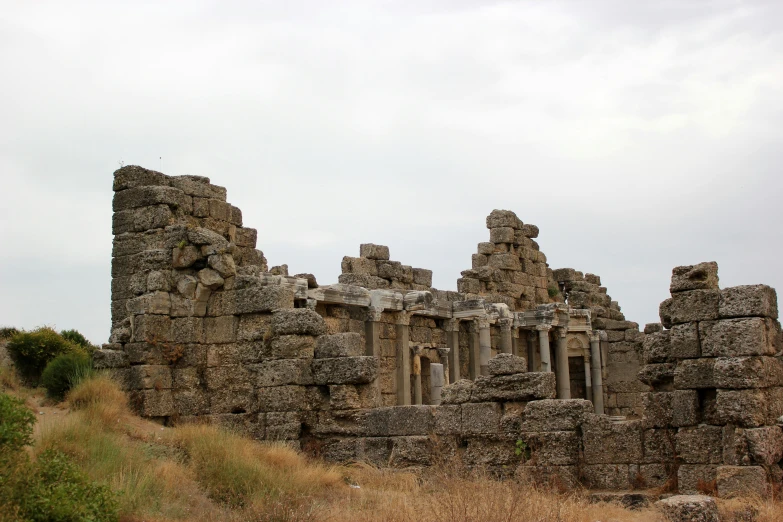 a large, old ruin stands near a grassy area