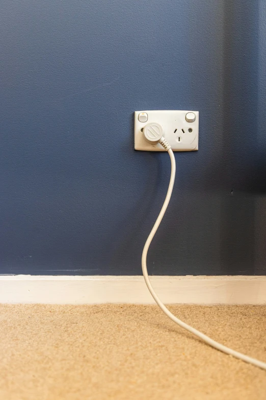 a plug that is in the corner of a room