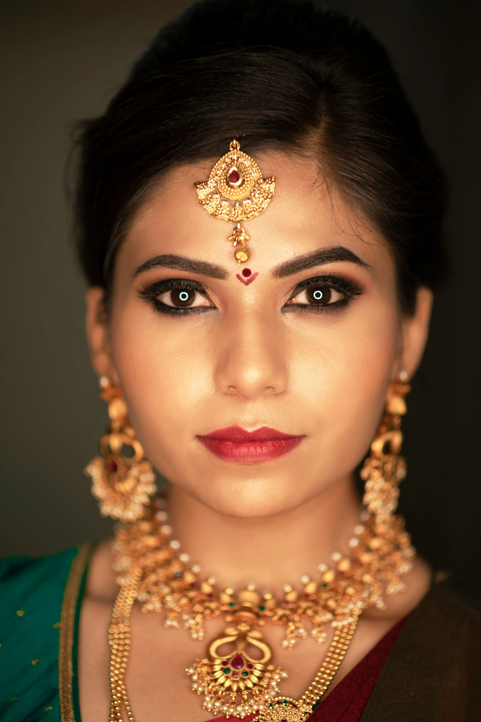 a woman with an intricate head piece and necklace