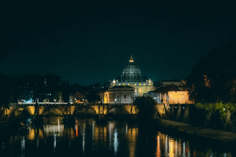 a river and bridge with lights in the dark