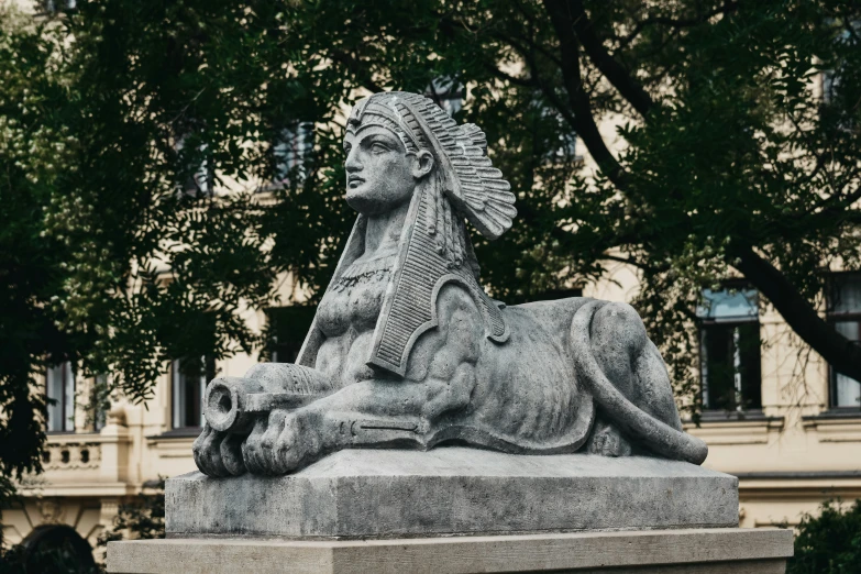 an old statue of a lion on the ground