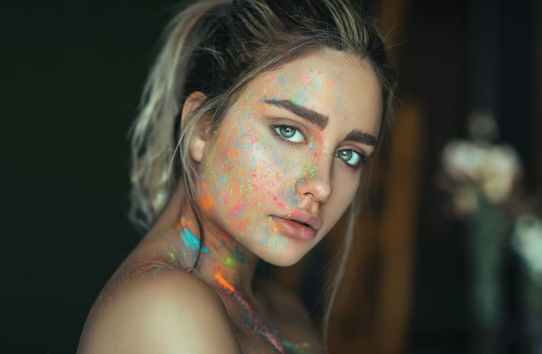 a beautiful woman with colorful make up on her face