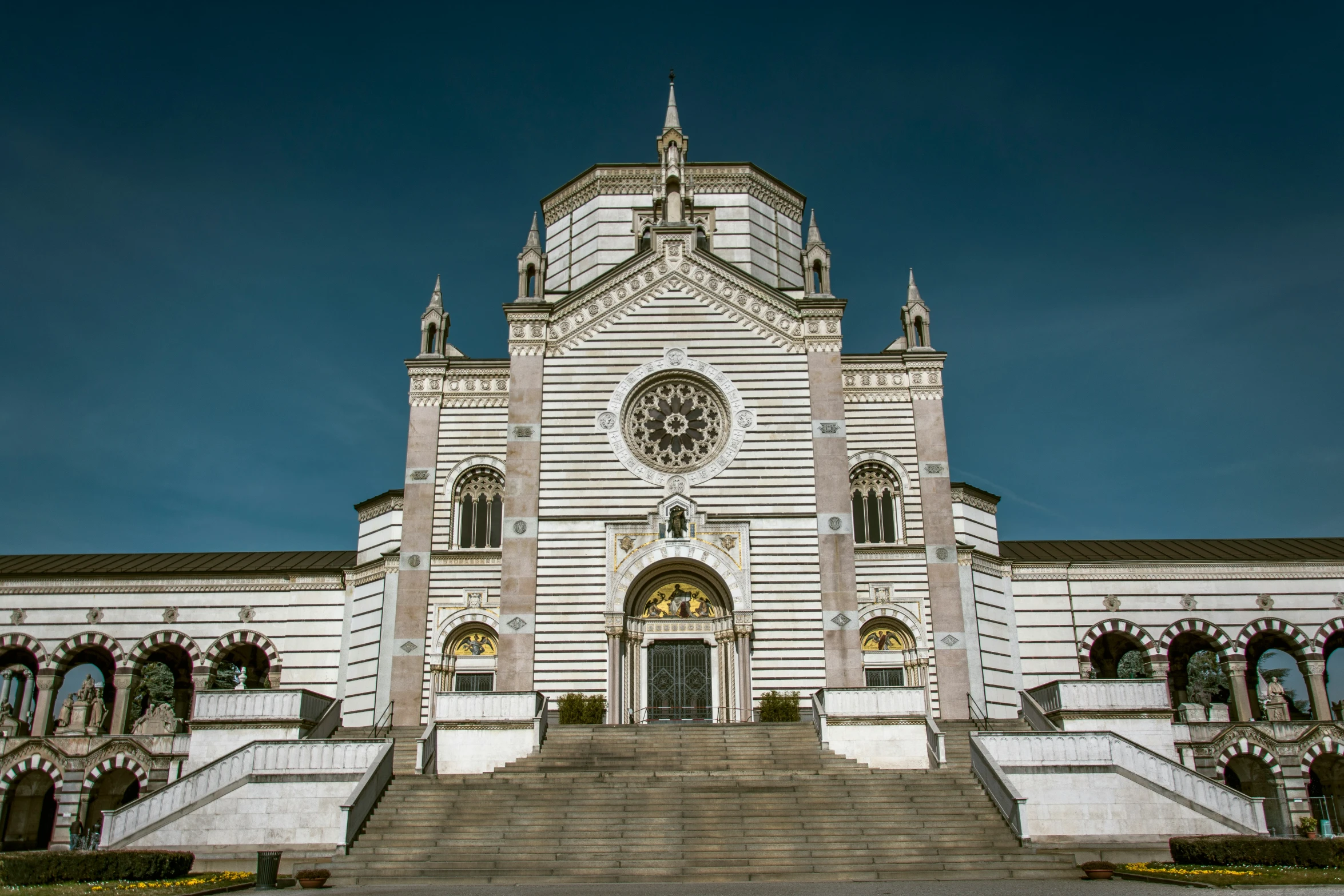 the stairway leading up to a large church with a clock on it