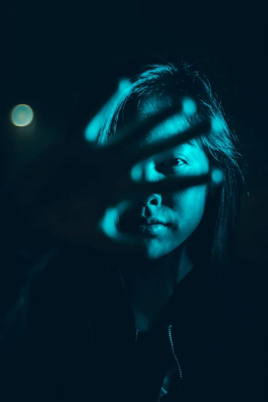 a male in a black shirt and a blue light