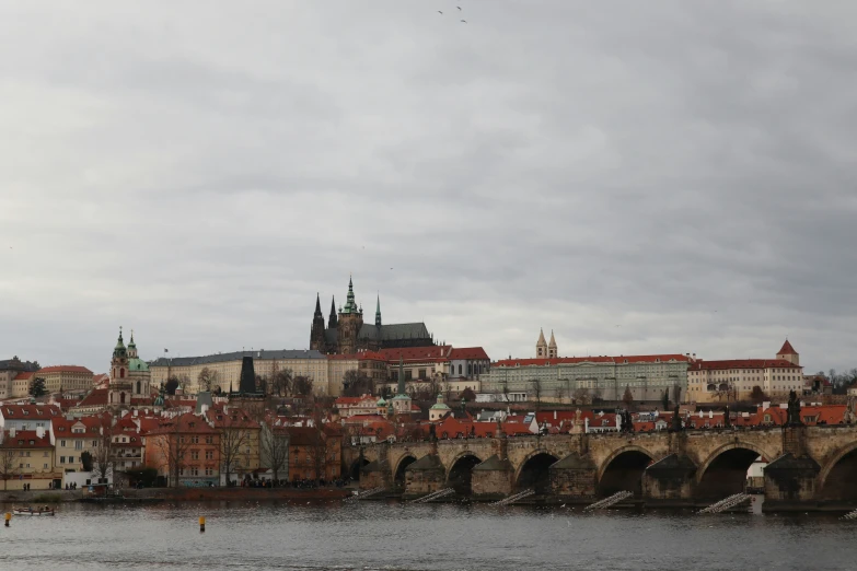 an old city with stone bridges and a bridge on the side of a river