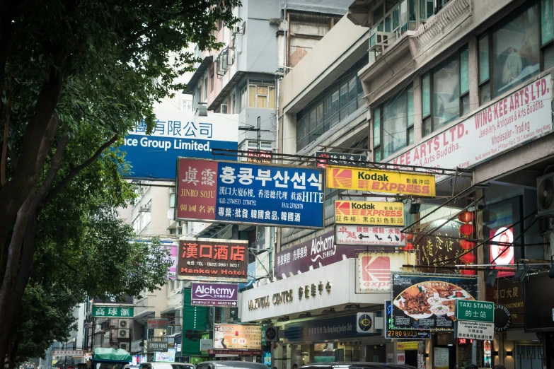 a bunch of signs posted on a busy city street