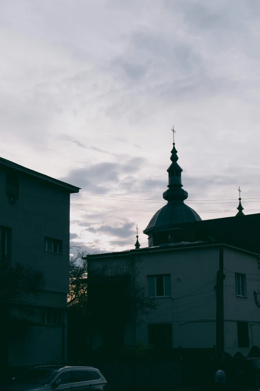 two buildings with three steeples and one sky line