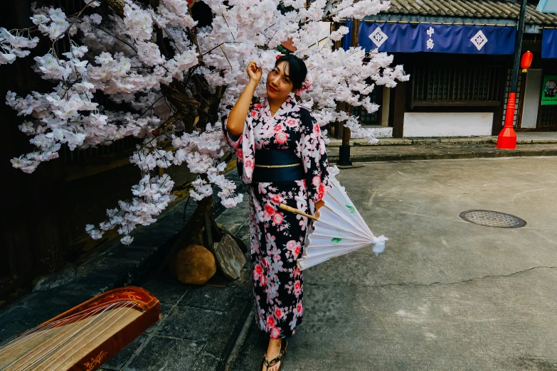 a woman is standing under a white umbrella