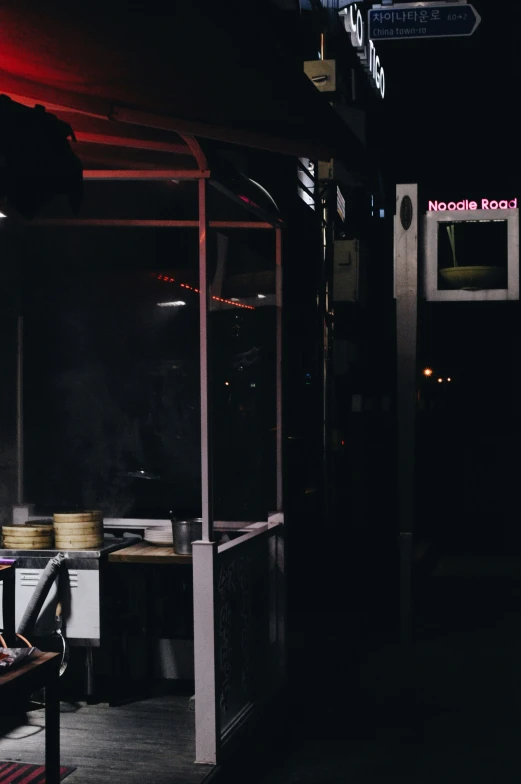 dark view of restaurant with food being cooked on a grill