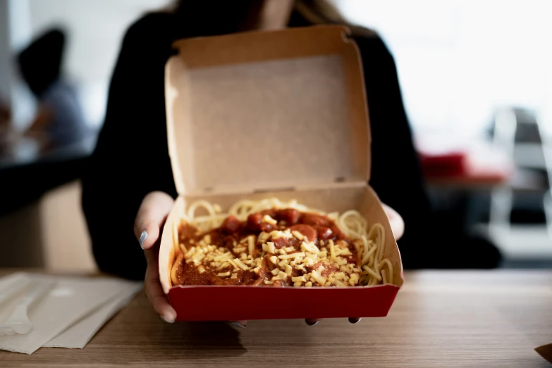 a box containing spaghetti with sauce and seasoning