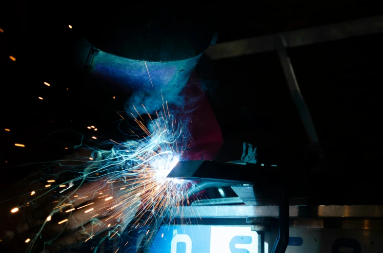 welder works with wires in the dark