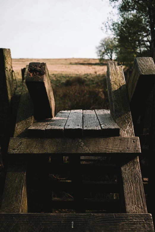 a wooden table with two chairs next to it