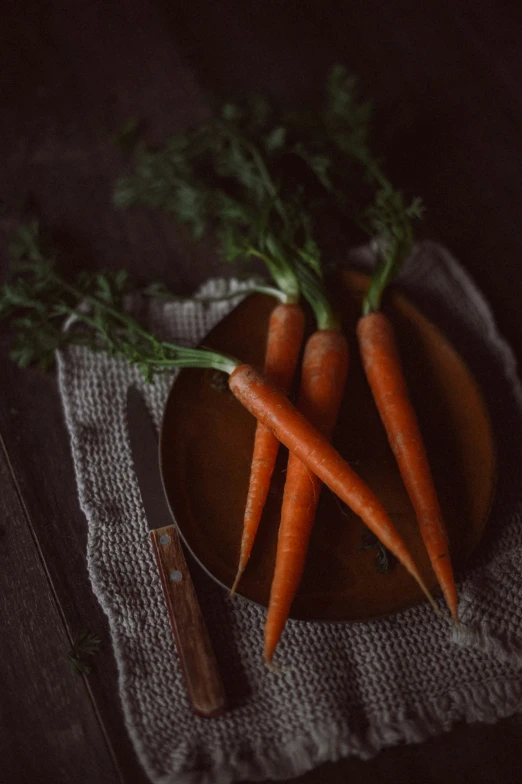 some very pretty carrots on top of a brown plate