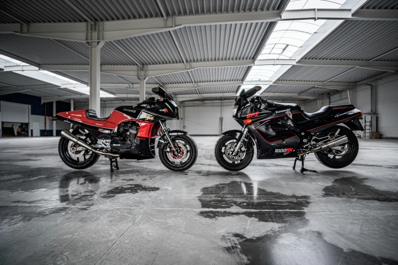 two motorcycles parked side by side in a warehouse