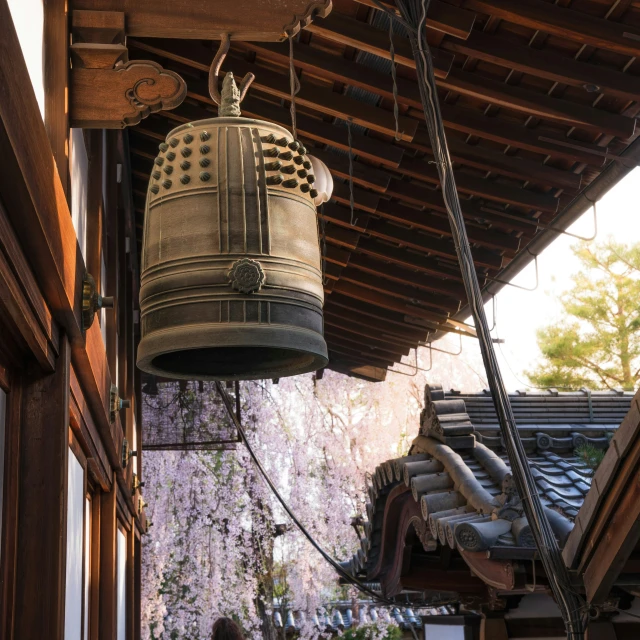 two bells hanging from the roof of a building