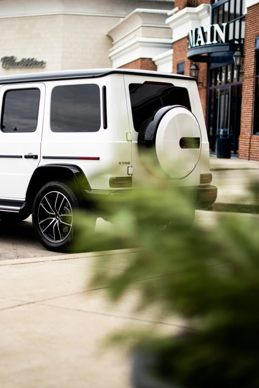 a white vehicle parked next to a building