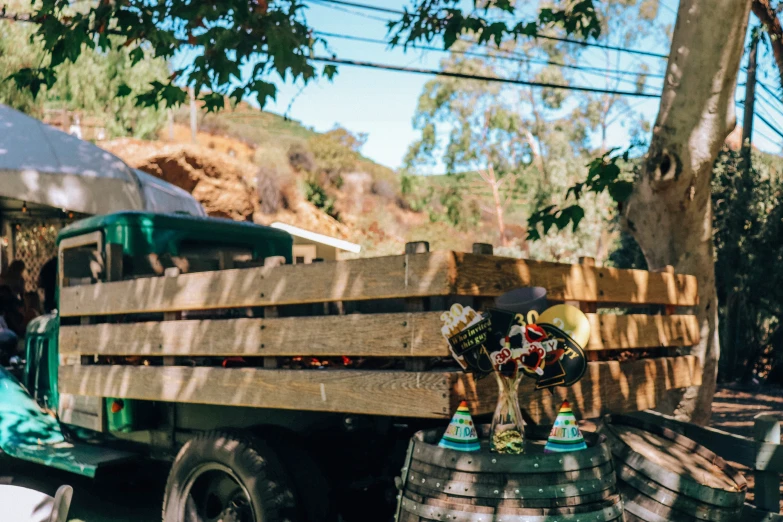 a green truck with two beer kegs in it