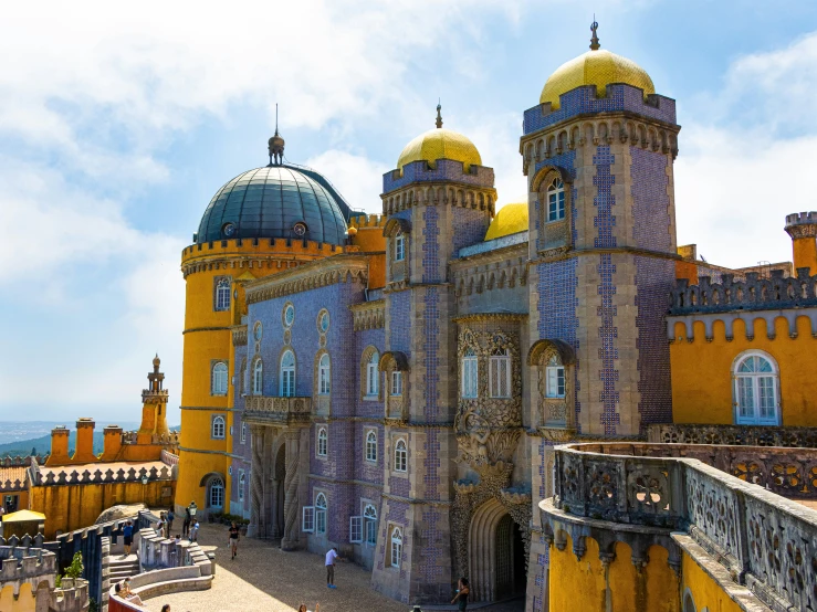 a building with domes, yellow roof and yellow walls