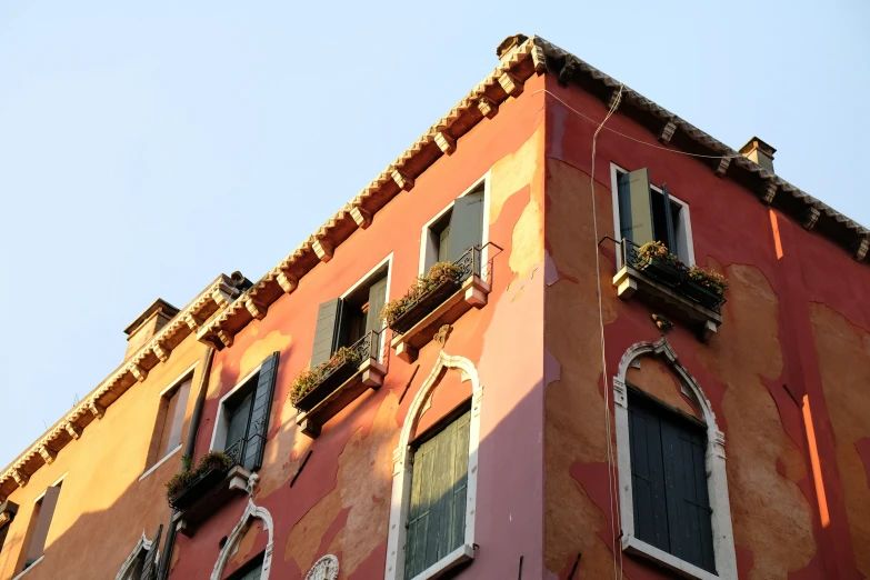 a building with balconies and arched windows and blue sky