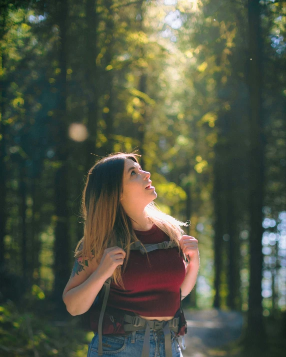 a woman standing in front of some trees