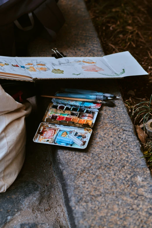 an opened notebook with a colorful picture of cats in the page of the book