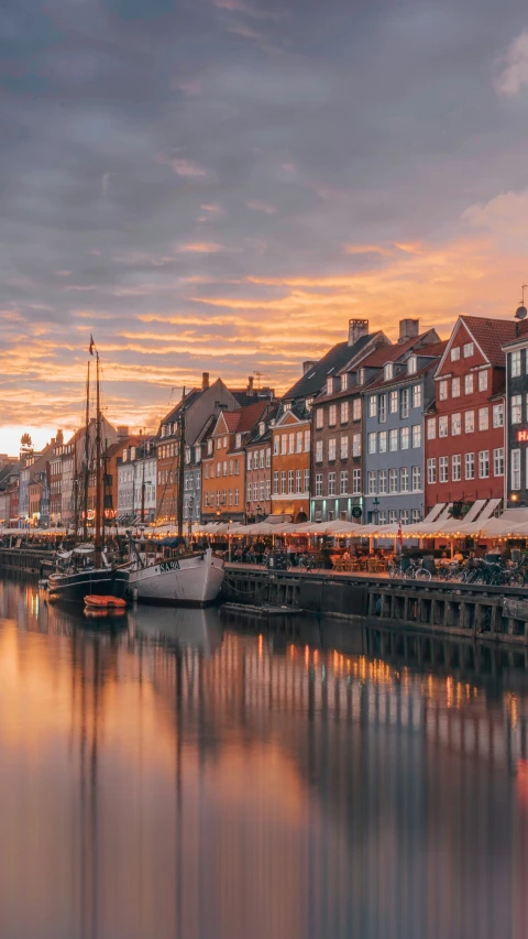 a city next to water at dusk