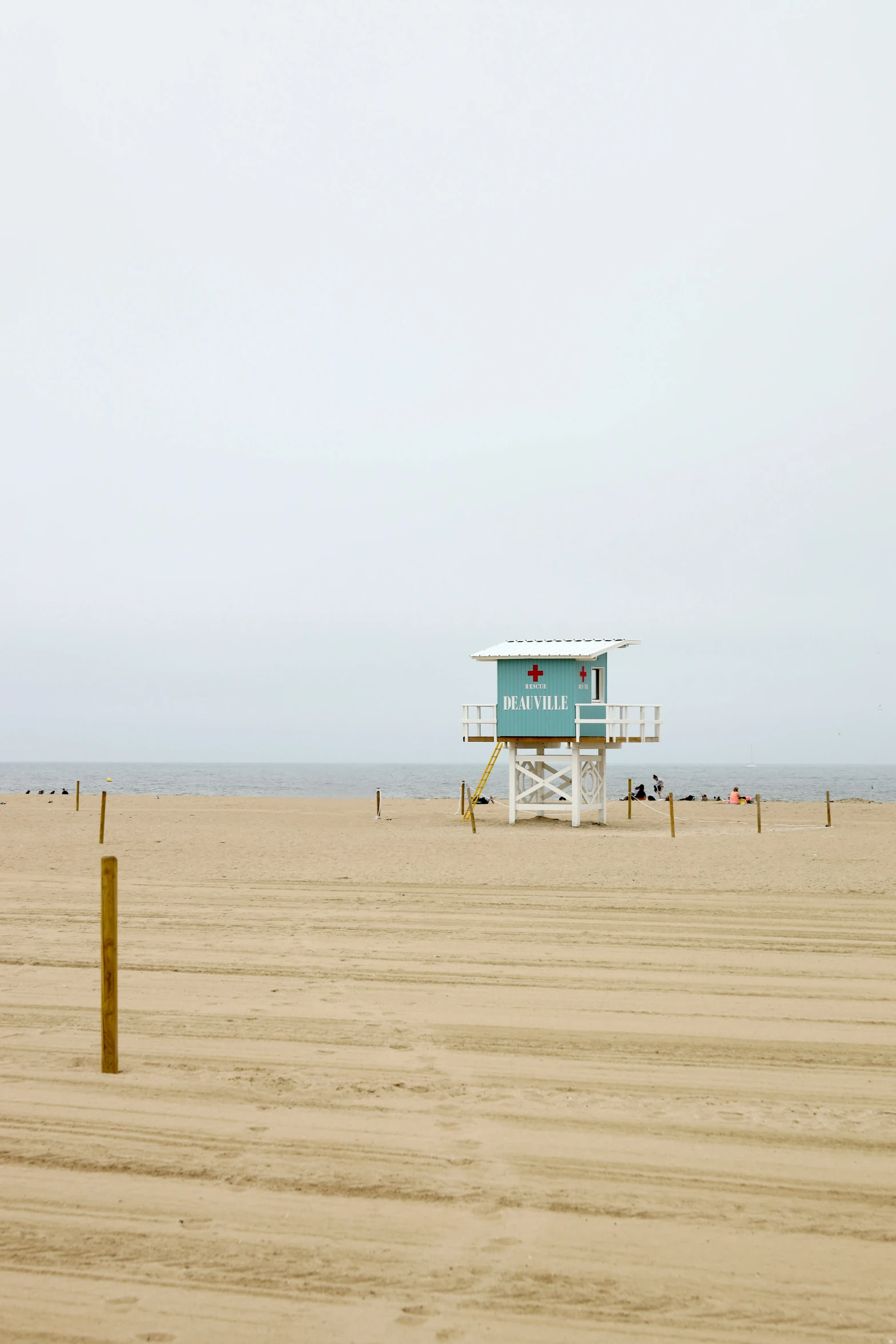 people are relaxing on the beach next to the ocean