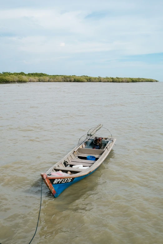 the small boat is tied up in the water