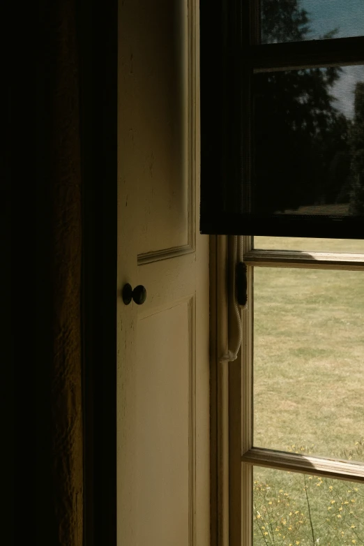 an open window next to the outside door of a house