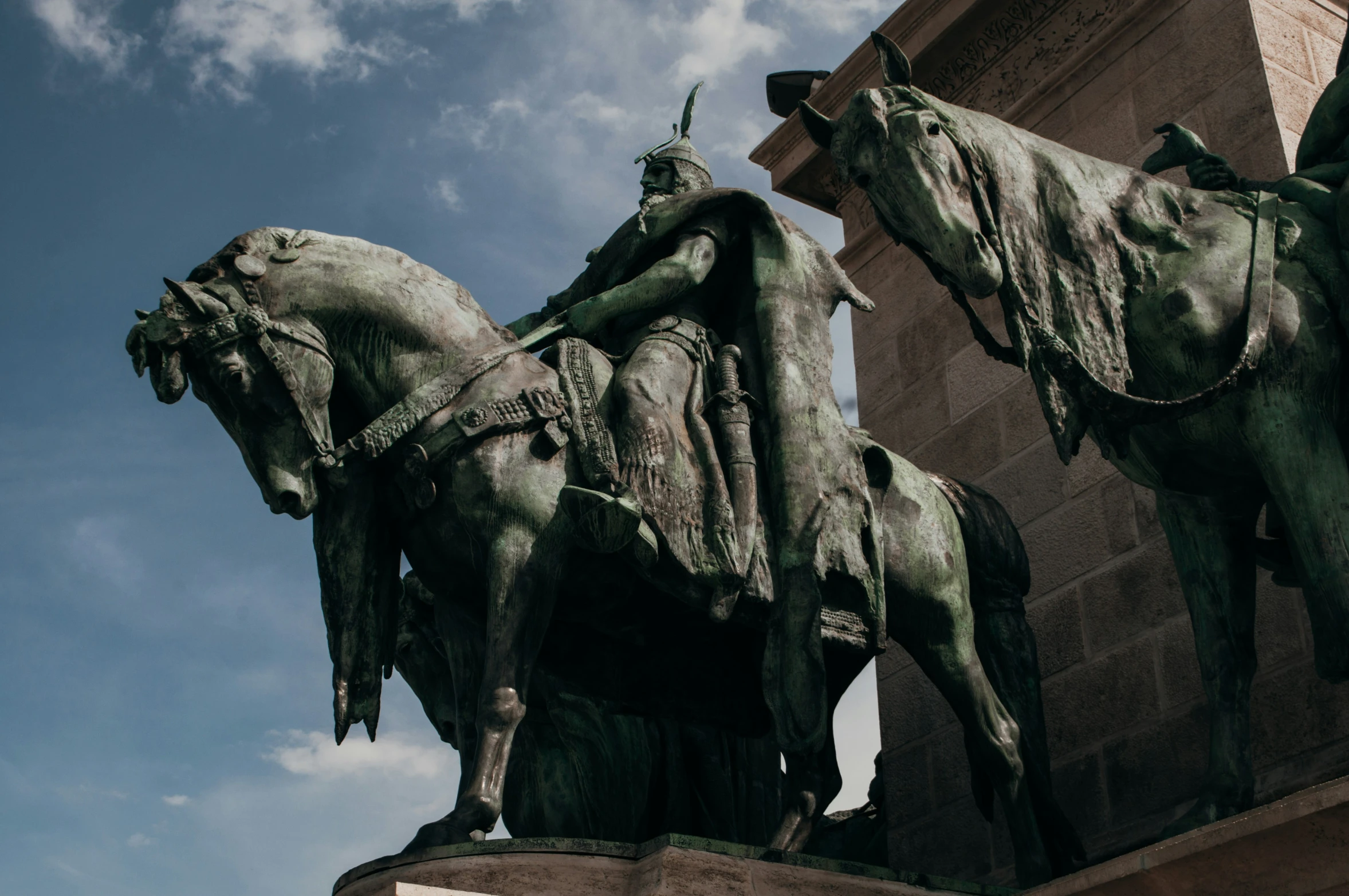 two statues that look like horses and riders